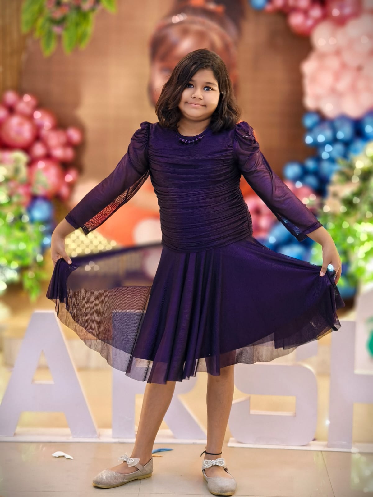 Aarohi smiling in a beautiful purple dress